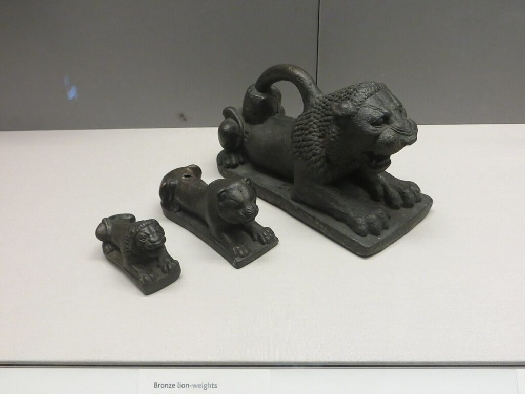 Series of Assyrian lion-shaped official weights from Nimrud used to calibrate heavy measures in palace trade.
