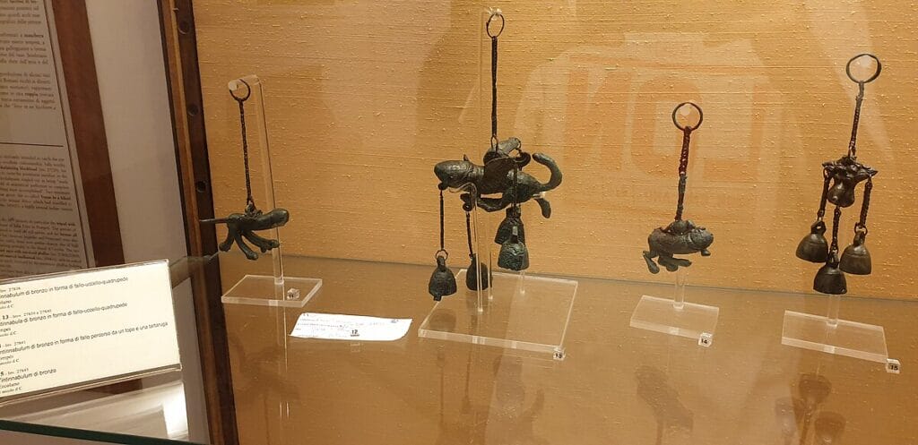 Bronze phallic amulets from the Naples Archaeological Museum, displayed as a group.