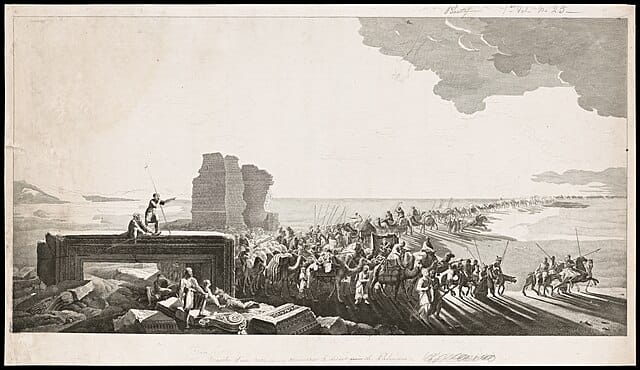 Camel train near the ruins of Palmyra against a desert backdrop