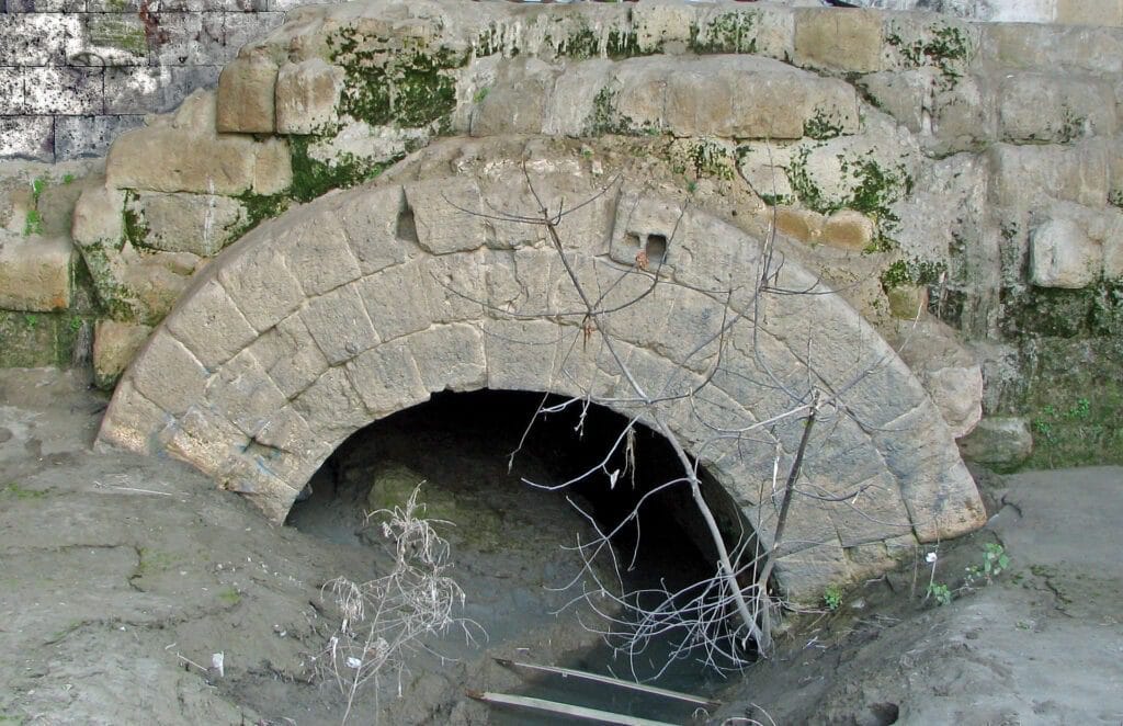 Ancient Infrastructure: arched stone outlet of the Cloaca Maxima sewer into the Tiber