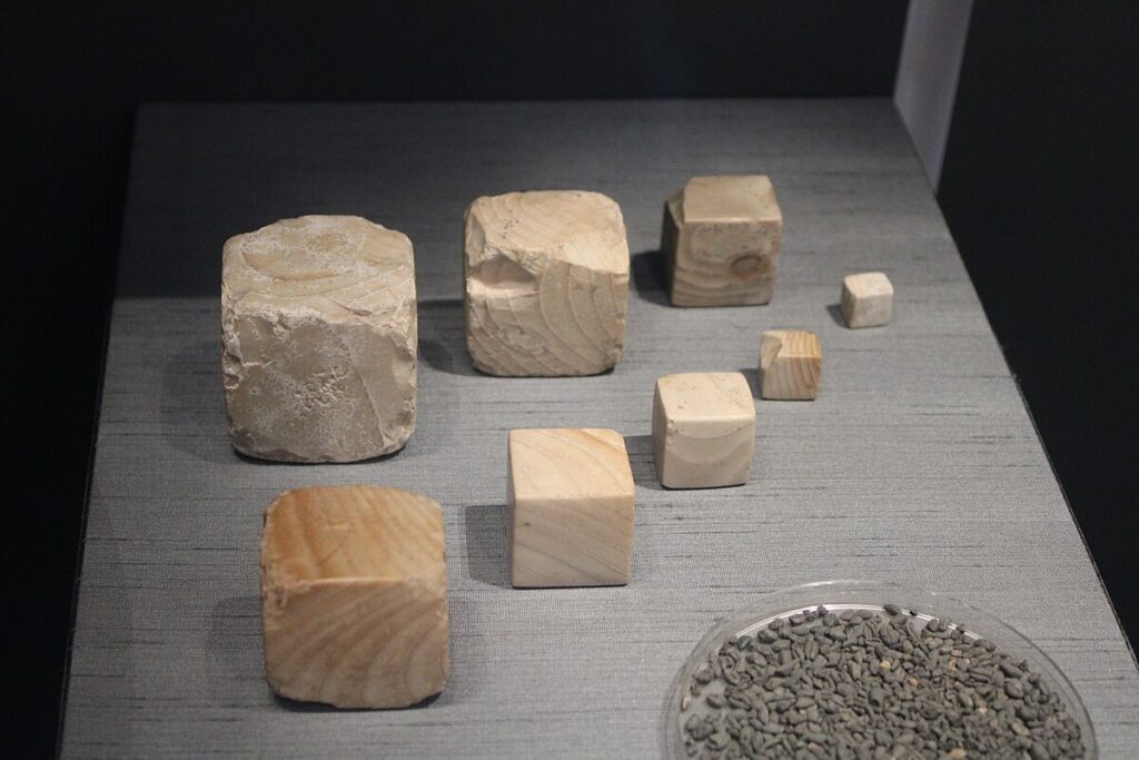 Standardised chert cube weights from the Indus Valley Civilisation used with beam balances for trade and accounting.