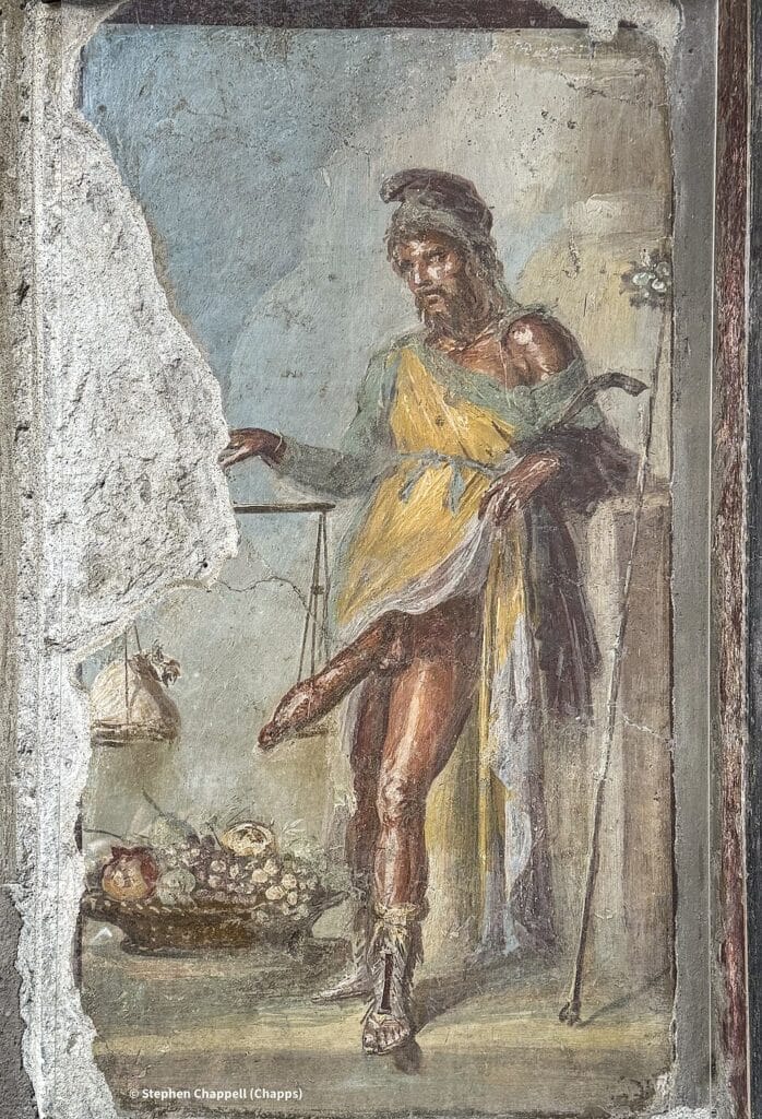 Priapus fresco at the House of the Vettii in Pompeii, showing the god weighing his phallus against a money bag.