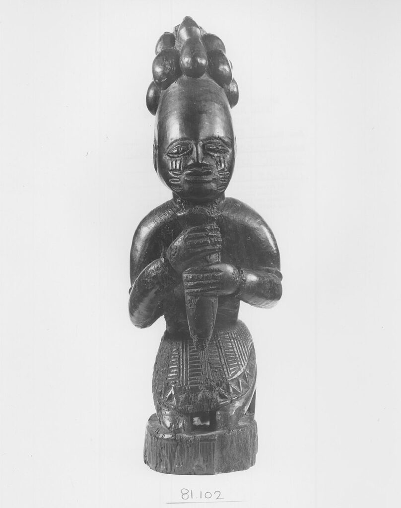 Wooden figure of Eshu-Elegba, messenger and guardian of the crossroads in Yoruba tradition.