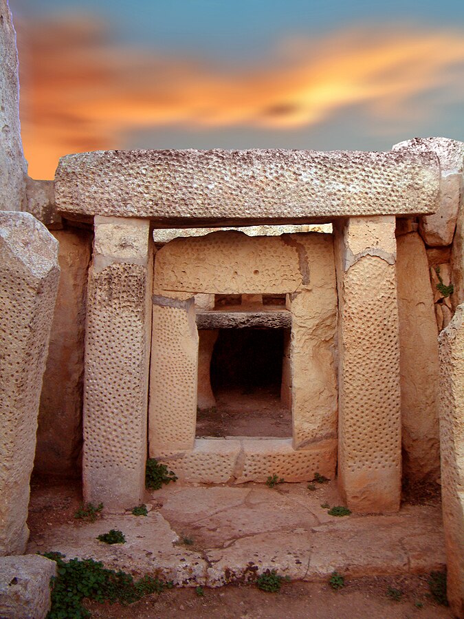 Equinox sunrise at Mnajdra's South temple, with light travelling down the axial corridor towards the inner niche.
