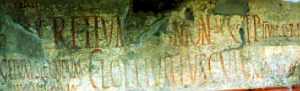 Cluster of incised and painted Latin graffiti on a Pompeian wall, including names, greetings, and phrases.