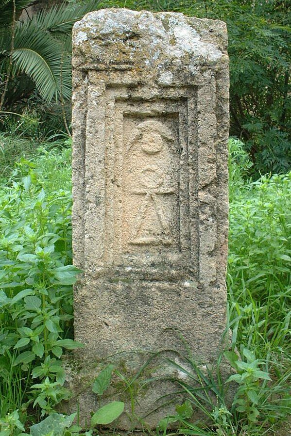 Stone stele bearing the triangle-bar-circle glyph associated with Tanit.