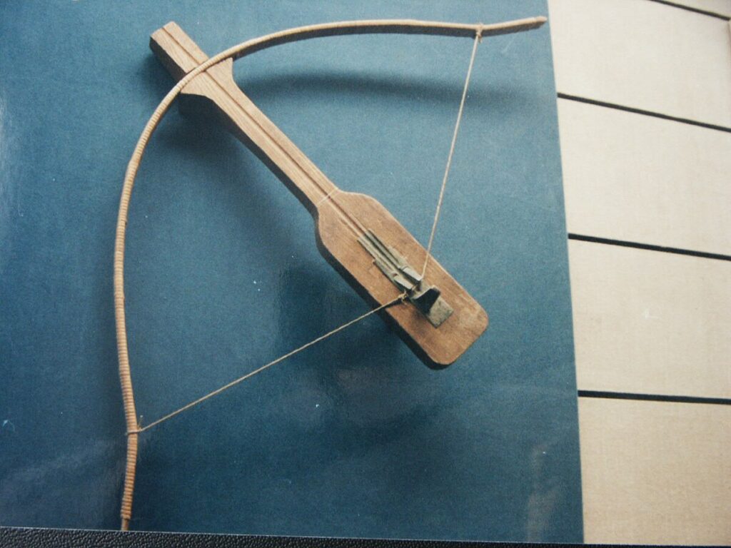 Museum display of a Qin bronze crossbow trigger assembly.