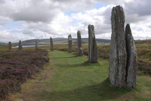 Distant view of the Ring of Brodgar stone circle on Orkney against an open horizon.