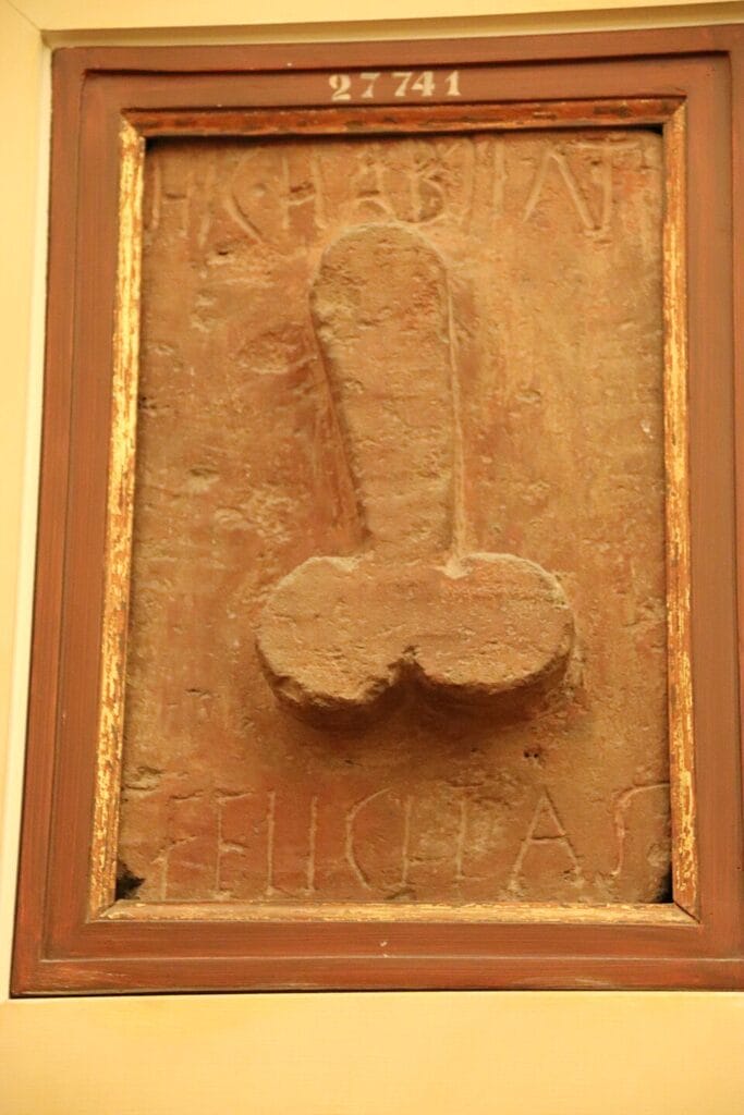 Stone relief with phallus and the inscription