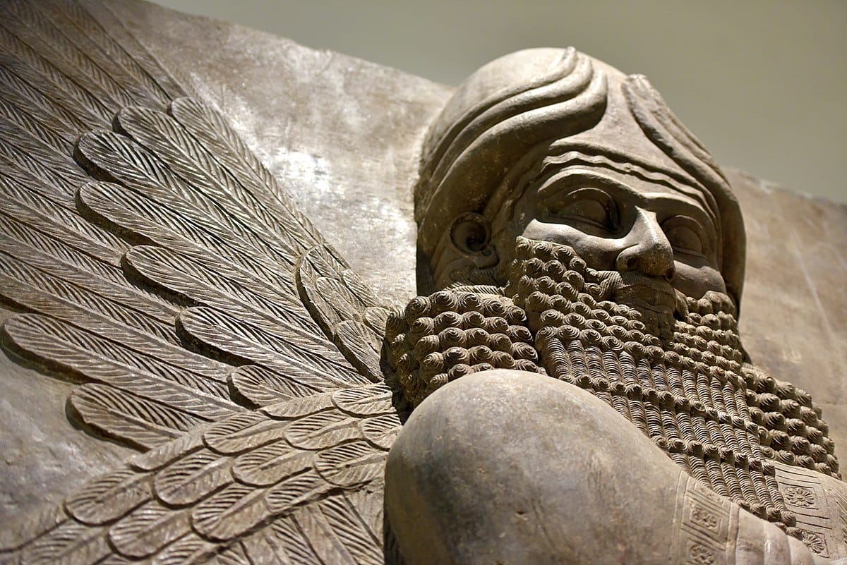 Human-headed winged Apkallu relief with rosette motifs.